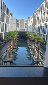 a row of palm trees in a courtyard in a building at Luxury appartement in La Marsa