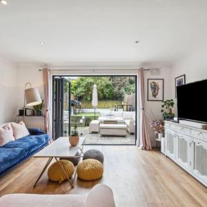 a living room with a couch and a table at Kings Cross Walking Distance Luxury Private Garden House in London