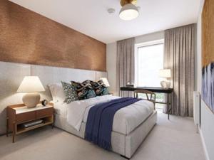 a bedroom with a bed and a desk in it at Kings Cross Walking Distance Luxury Private Garden House in London