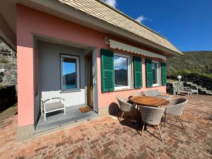 a house with a table and chairs on a patio at Villa Marta in Levanto