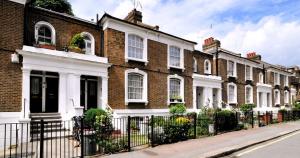 a row of brick houses on a street at Kings Cross Walking Distance Luxury Private Garden House in London