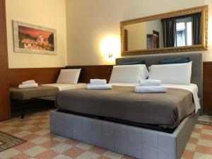 Postel nebo postele na pokoji v ubytování A ROSMINI SUITES