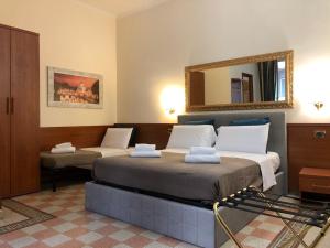 Postel nebo postele na pokoji v ubytování A ROSMINI SUITES