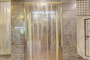 a shower with a glass door in a bathroom at Hotel Ramoji in Surūrnagar