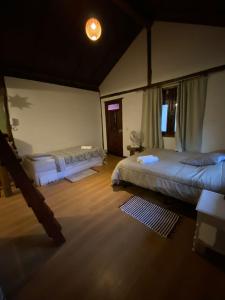 a bedroom with two beds and a light on the ceiling at Amanduarte Brasília in Brasília