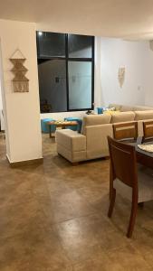 a living room with a couch and a table at Casa de Playa moderna in Lima