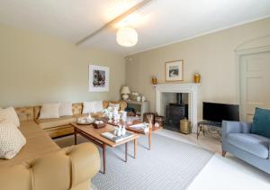 a living room with a couch and a table at Dilham House in Dilham