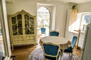 a kitchen with a table and chairs and a cabinet at Ferienwohnung Kaiserblick in Bad Ems +11 photos