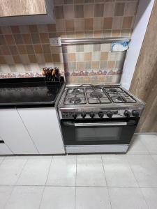 a kitchen with a stove top oven in a kitchen at الشيخ زايد in Cairo