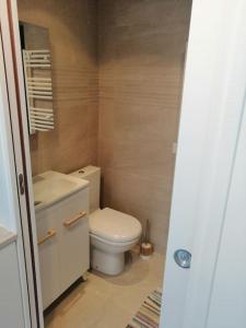 a small bathroom with a toilet and a sink at Logement+parking proche métro - total autonome in Villejuif