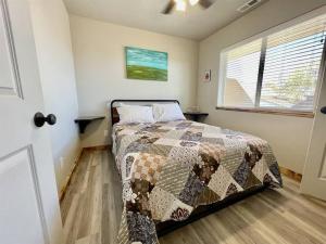 a bedroom with a bed with a quilt on it at Angel Rock Rentals of Moab Unit 10 in Moab