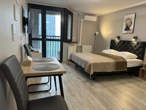 a hotel room with a bed and a table and a table sidx sidx at PRZYSTANEK KATOWICE Aleja Korfantego 8 in Katowice