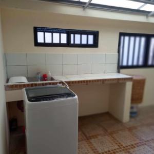 a kitchen with a counter and a trash can at Trails of Maia Alta Staycation in Antipolo