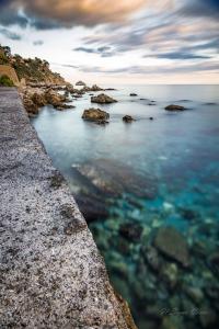 a view of the ocean with rocks in the water at Il Signò Cocco mare apartment in Taormina