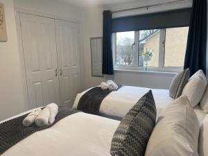 a bedroom with two beds and a window at E.C.A.S. Pitreavie Castle 2 Bed Executive Apartment in Fife