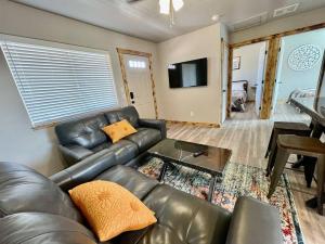 a living room with a leather couch and a table at Angel Rock Rentals of Moab Unit 11 in Moab