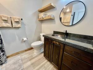 a bathroom with a sink and a toilet and a mirror at Angel Rock Rentals of Moab Unit 11 in Moab