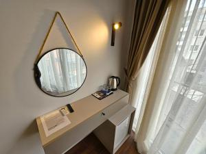 a dressing table with a mirror next to a window at Lolo Luxury rooms & suites in Budva