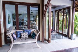 a living room with a couch on a patio at Villa Penyon in Nusa Lembongan