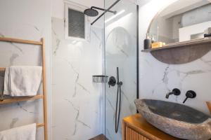 a bathroom with a stone sink and a shower at A Place 4 U no13 in Athens