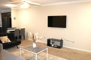 a living room with a couch and a tv on the wall at Lubbock haven 3Beds, 3 baths in Lubbock