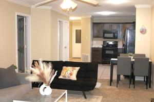 a living room with a black couch and a table at Lubbock haven 3Beds, 3 baths in Lubbock