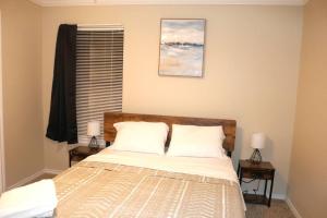 a bedroom with a bed with two night stands and two lamps at Lubbock haven 3Beds, 3 baths in Lubbock