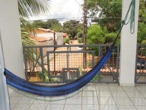a hammock on the balcony of a house at Pedroca Hostel in Palmas