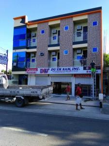 un camión está estacionado frente a un edificio en Argao Aballe Pension House/Apartelle en Argao