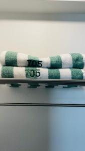 a stack of towels sitting on a shelf at SkyGarden Nunciatura Luxury Apartment in San José