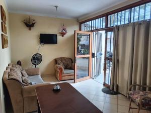 a living room with a couch and a table at Hospedaje Guadalupe Inn in Máncora