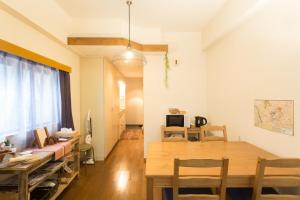 a dining room and living room with a wooden table at Tipy records room in Odawara