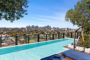a swimming pool with a view of the city at Elegant Inner-West 2-Bed with City Views & Pool in Melbourne