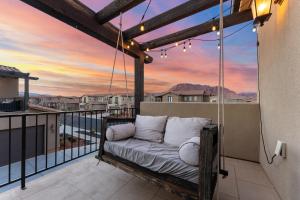 a swinging bed on a balcony with a sunset at Double the Fun combo - Canyon Springs 76 and Desert Moose 75 home in Santa Clara