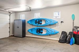 two blue kayaks on display in a garage at Double the Fun combo - Canyon Springs 76 and Desert Moose 75 home in Santa Clara