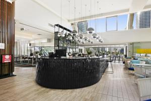 a lobby with a bar in the middle of a building at Sleek and Central Studio Apartment in Gold Coast