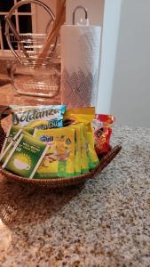 a basket filled with toothbrushes and a roll of paper towels at Island Hideaway in Falmouth