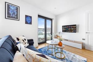 a living room with a blue couch and a table at OCEAN BLUEZ 1bdr city centre in Hemel Hempstead