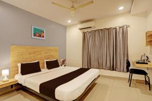 a bedroom with a large bed and a window at Hotel Ramoji in Surūrnagar