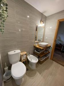 a bathroom with a toilet and a sink at Casa da Bivó in Figueiró dos Vinhos +20 photos