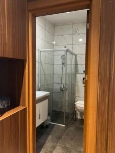 a bathroom with a glass shower and a toilet at Besiktas KonukEvi in Istanbul
