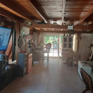 a living room with a television and a dining room at LE CHALET in Barranquilla