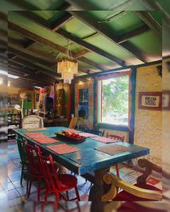 a dining room with a blue table and chairs at Hostal Camino Viejo in Líbano