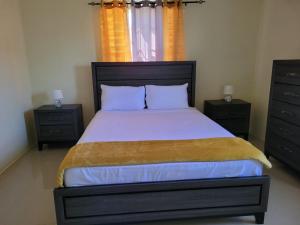 a bedroom with a large bed with two night stands at Island Hideaway in Falmouth