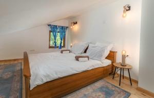 a bedroom with a bed with white sheets and a window at Family friendly house with a parking space Dragovanscak, Prigorje - 22529 in Jastrebarsko