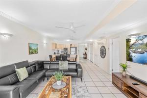 a living room with a couch and a table at Cairns City Apartments in Cairns