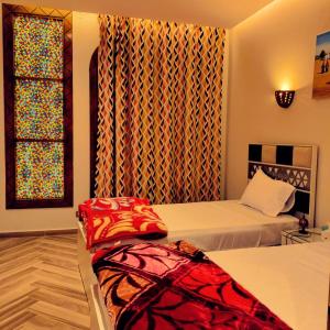a bedroom with two beds and a window at New Abusimble 2 Hotel & Restaurant in Abu Simbel