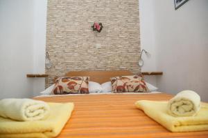 a bedroom with a bed with two towels on it at Apartments by the sea Milna, Hvar - 22619 in Hvar