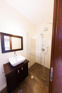 a bathroom with a sink and a shower at Five Stars Villa09 in Hod HaSharon +50 photos