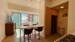 a kitchen with a table and chairs and a window at Ocean View Retreat with Pool and Jacuzzi in Tijuana